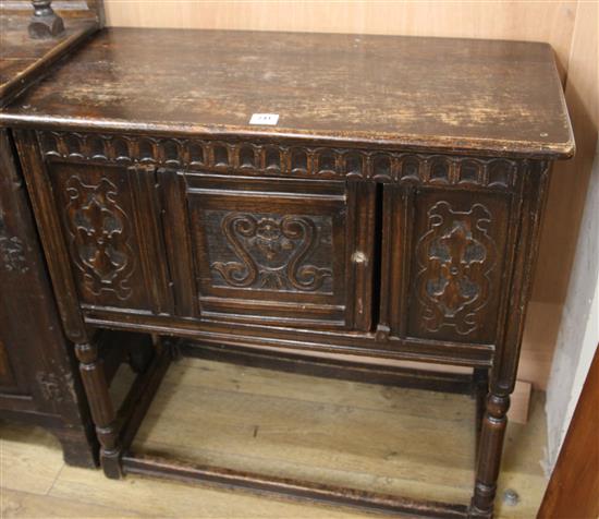 A carved oak cupboard W.91cm